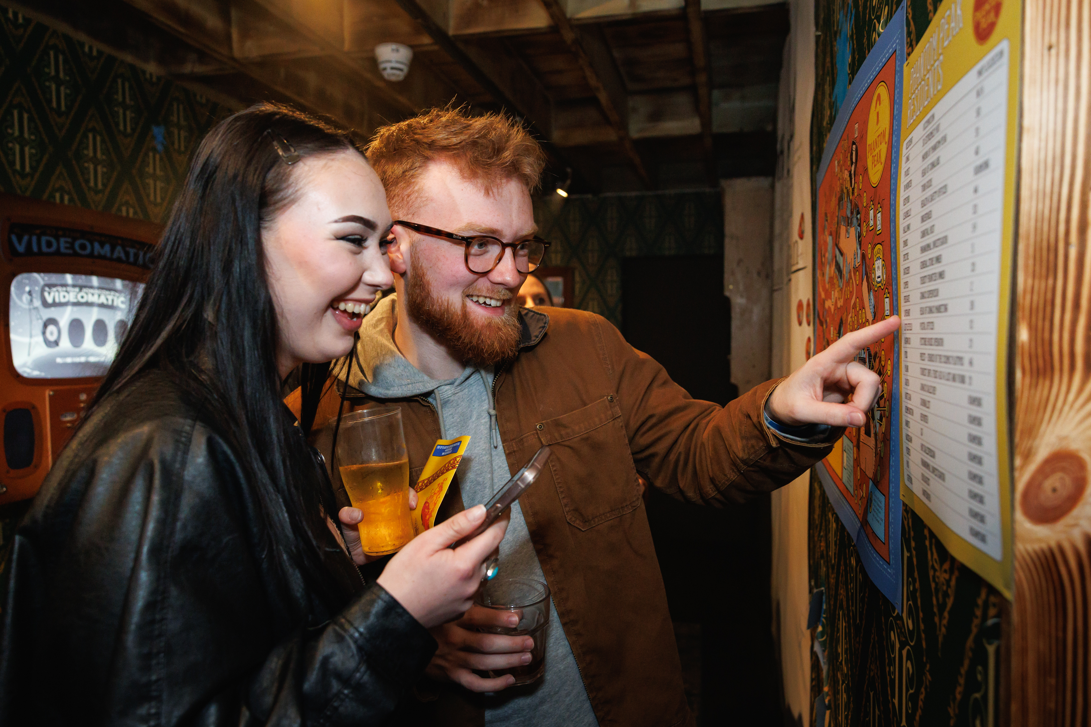 Two guests of Phantom Peak enjoying themselves and looking at a poster